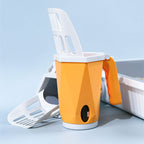 Orange litter scoop holder next to a litter tray