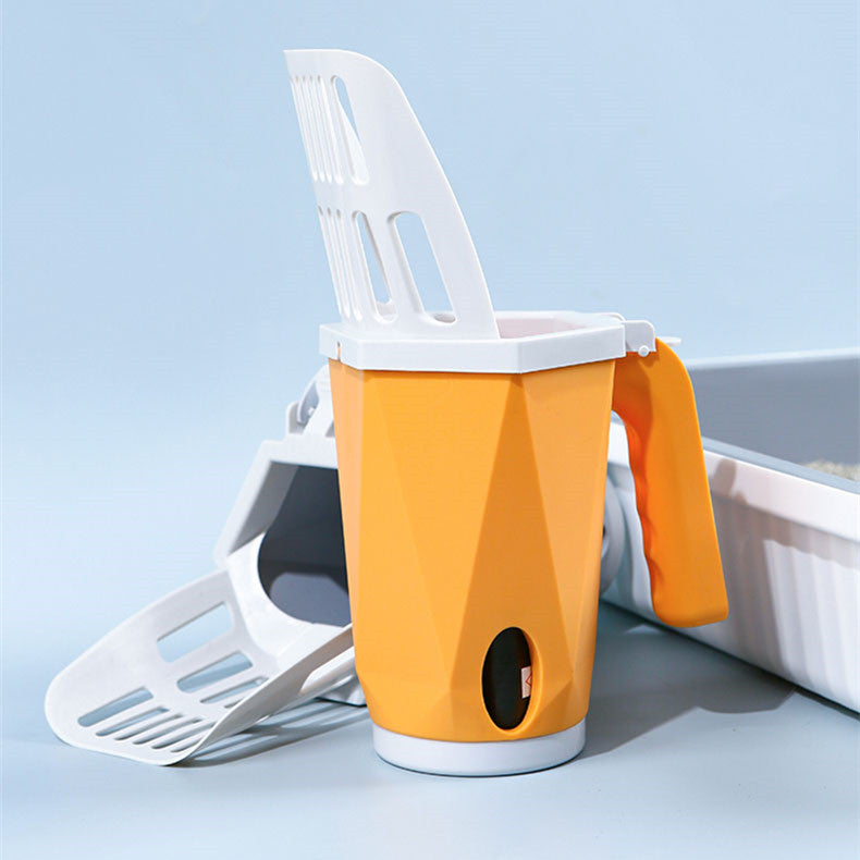 Orange litter scoop holder next to a litter tray