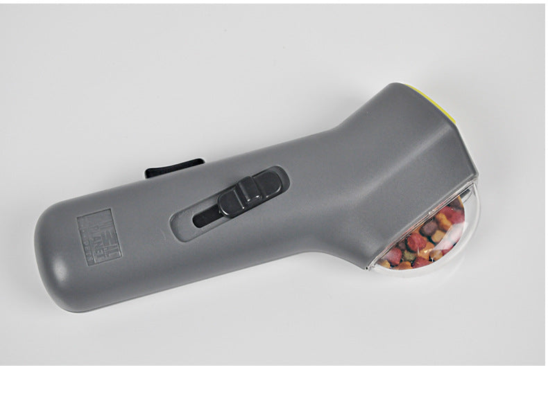 Dog treat launcher with treats loaded in the clear top