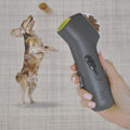 Dog leaping for a treat fired from the handheld dog treat launcher