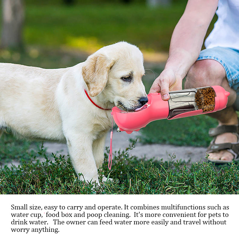 Puppy drinking from the dog walking water bottle outdoors